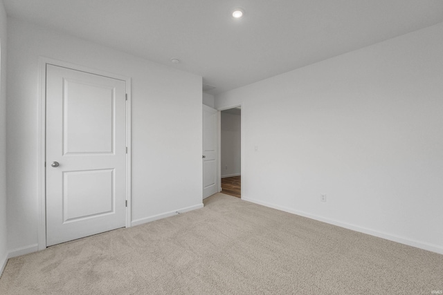 empty room featuring light colored carpet