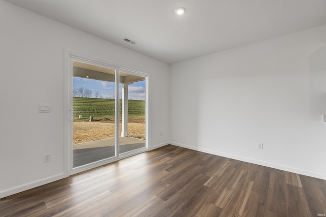 unfurnished room with dark wood-type flooring