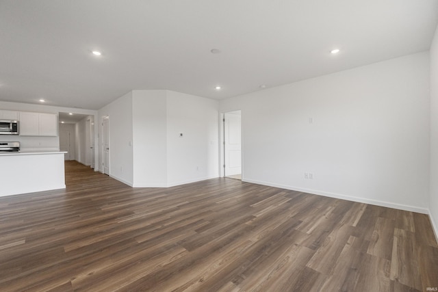 unfurnished living room featuring dark hardwood / wood-style flooring