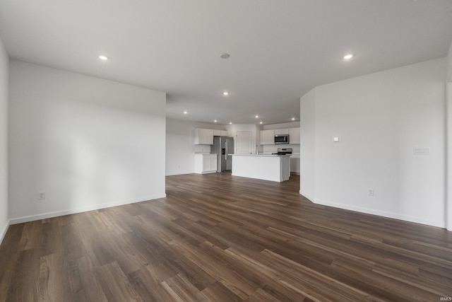 unfurnished living room with dark hardwood / wood-style floors