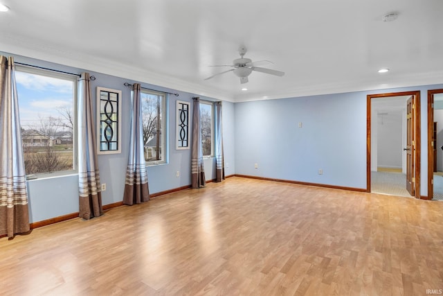 empty room with ceiling fan, light hardwood / wood-style floors, and crown molding