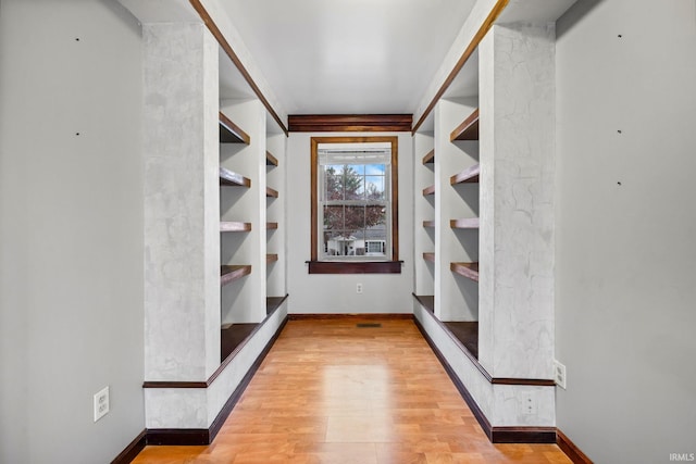 spacious closet featuring light hardwood / wood-style flooring