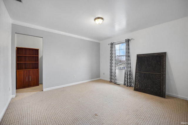 empty room with light colored carpet and ornamental molding