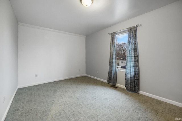 spare room featuring carpet floors and ornamental molding