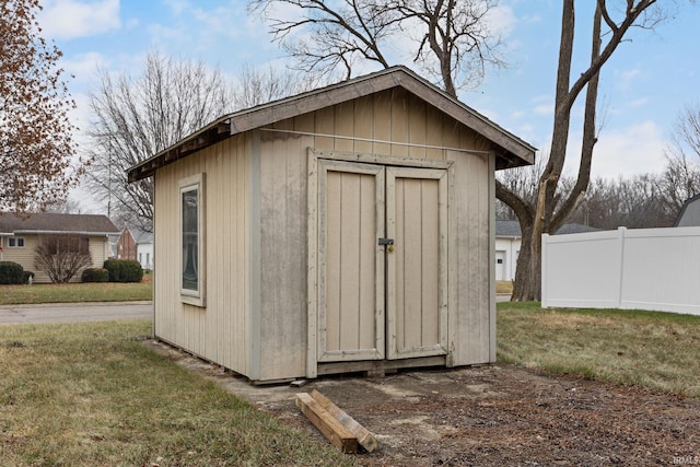 view of outbuilding featuring a lawn