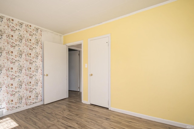 unfurnished room with hardwood / wood-style flooring and ornamental molding