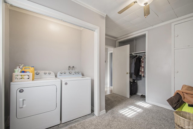 washroom featuring washing machine and clothes dryer, ceiling fan, light colored carpet, and ornamental molding