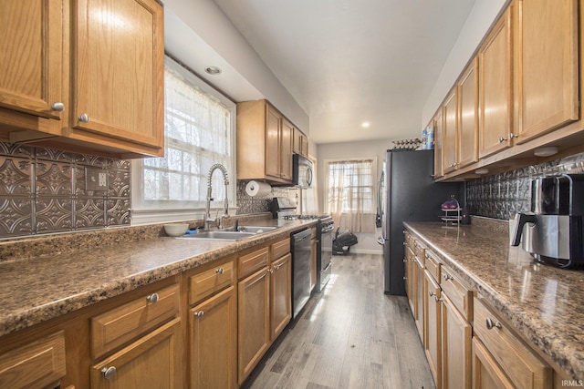 kitchen featuring appliances with stainless steel finishes, tasteful backsplash, and plenty of natural light