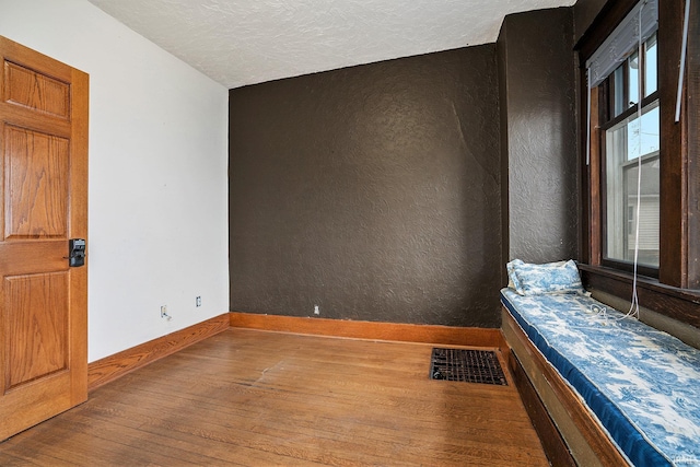 unfurnished room featuring hardwood / wood-style flooring