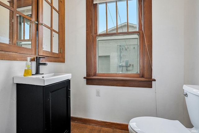 bathroom featuring hardwood / wood-style floors, vanity, and toilet