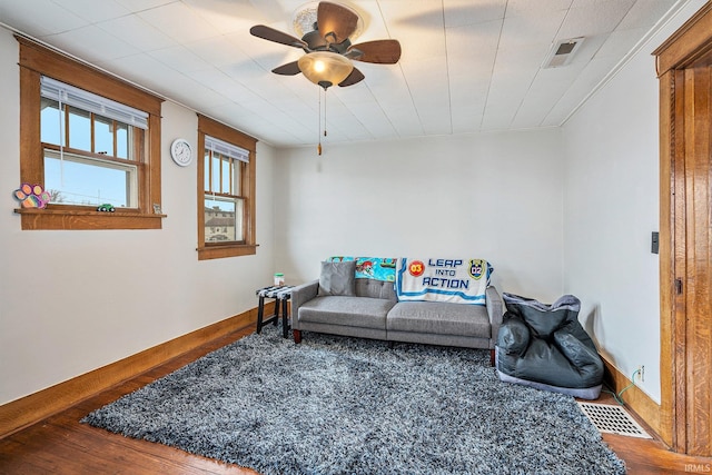 living room with wood-type flooring and ceiling fan