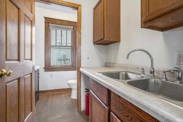 bathroom featuring hardwood / wood-style floors, toilet, and sink