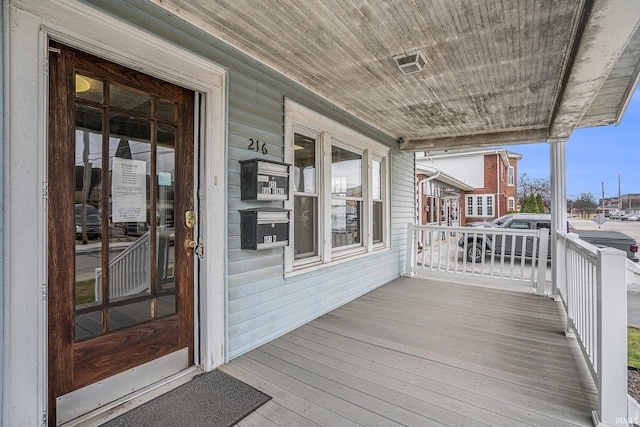 wooden terrace featuring covered porch