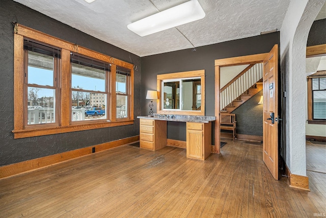 interior space with hardwood / wood-style flooring, vanity, and a textured ceiling