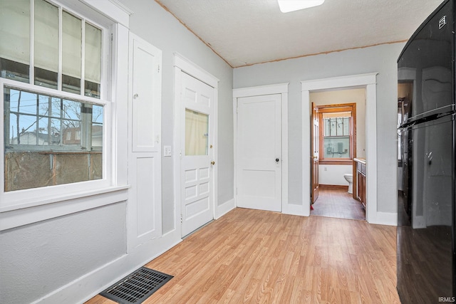 interior space with light hardwood / wood-style flooring and a healthy amount of sunlight