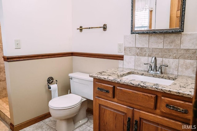 bathroom with tile patterned flooring, decorative backsplash, toilet, and vanity