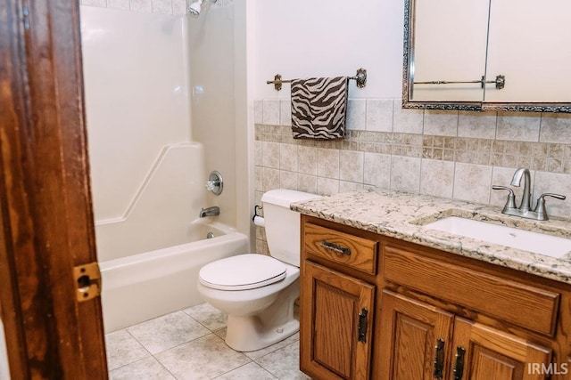 full bathroom with vanity, tile patterned floors, toilet, tile walls, and tub / shower combination