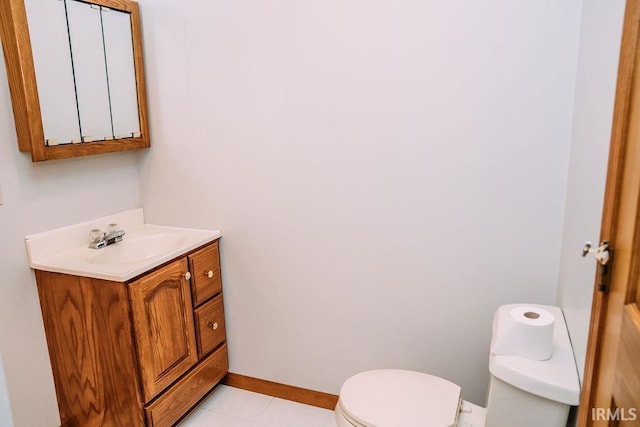 bathroom featuring tile patterned floors, vanity, and toilet