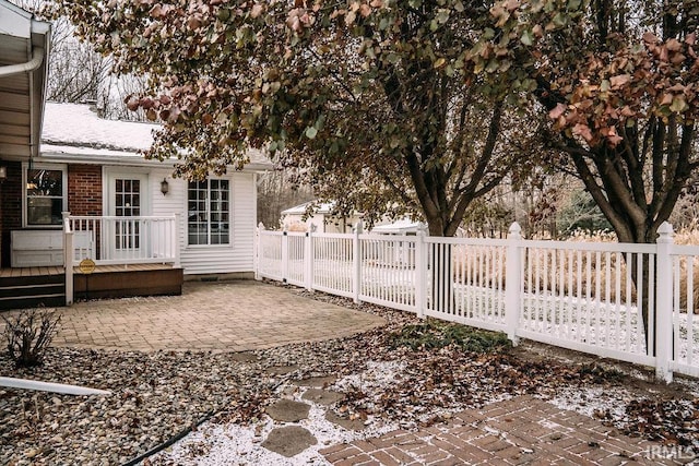 yard layered in snow featuring a patio