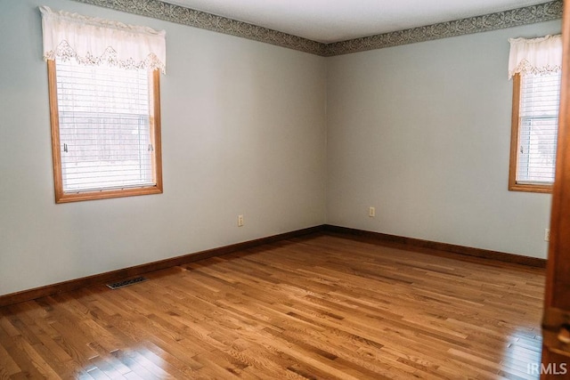 unfurnished room featuring wood-type flooring