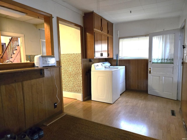 washroom with light wood-type flooring and washing machine and clothes dryer