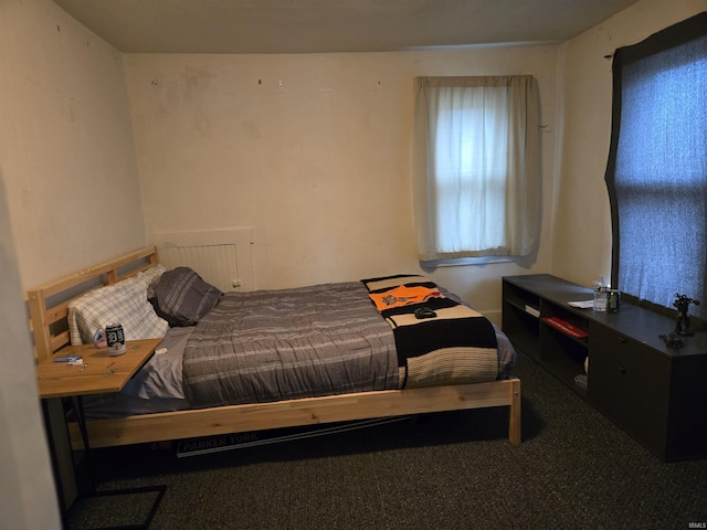 carpeted bedroom featuring radiator