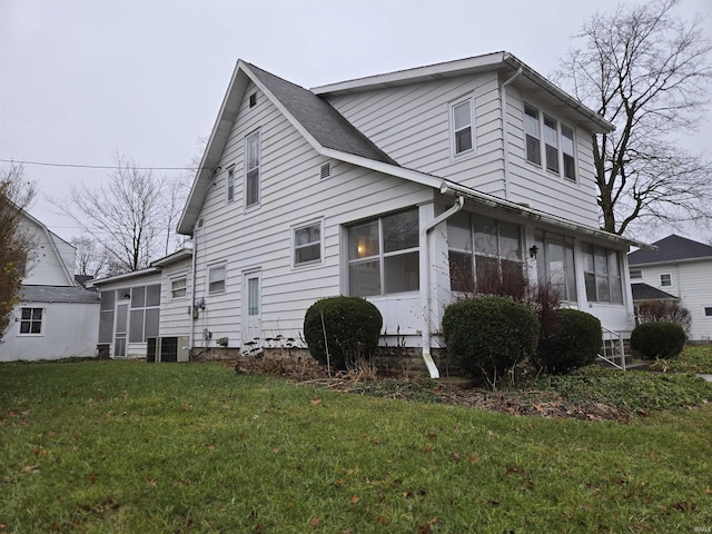 view of front of home with a front lawn and a sunroom