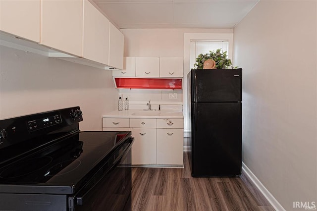 230 Vine St, Mount Vernon, IN 47620 - kitchen with dark wood-type flooring, light countertops, white cabinets, a sink, and black appliances