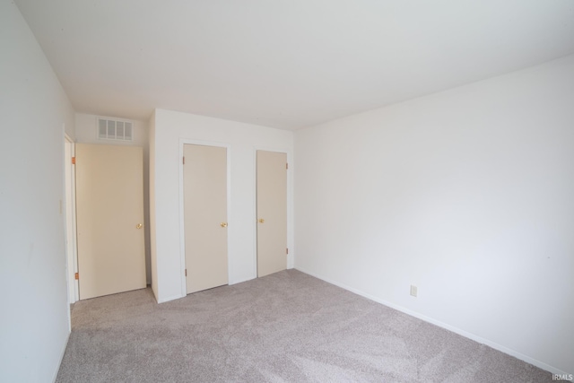 unfurnished bedroom with light carpet