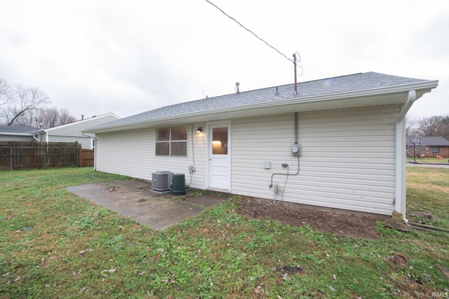 back of property featuring a lawn and central AC unit