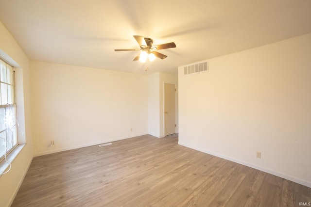 empty room with light wood-type flooring and ceiling fan