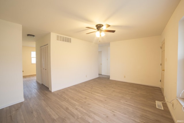 empty room with hardwood / wood-style floors and ceiling fan