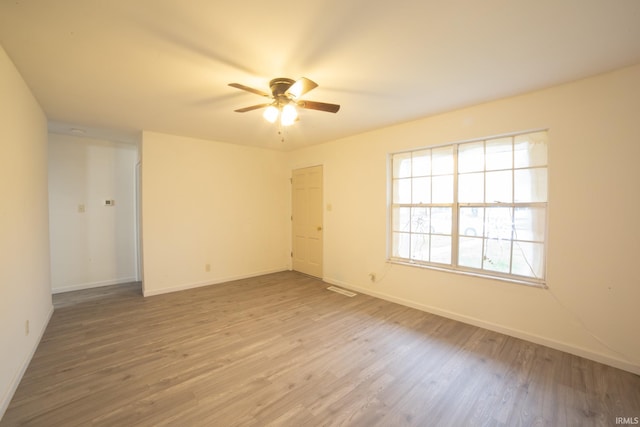 spare room featuring hardwood / wood-style flooring and ceiling fan