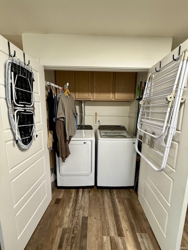 washroom with cabinets, washer and dryer, and dark hardwood / wood-style flooring