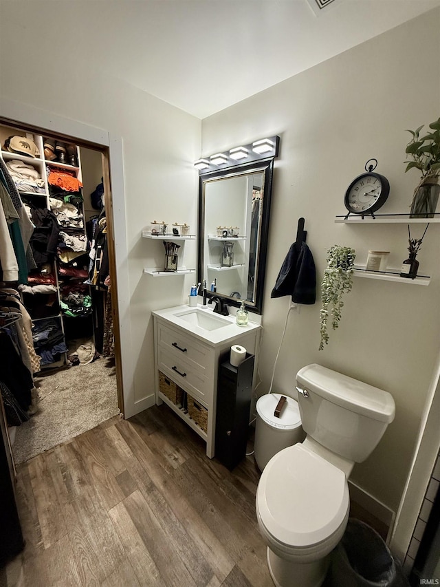 bathroom featuring vanity, toilet, and wood-type flooring