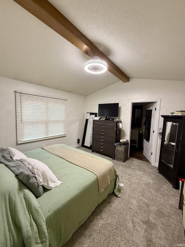 bedroom featuring lofted ceiling with beams, carpet floors, and a textured ceiling