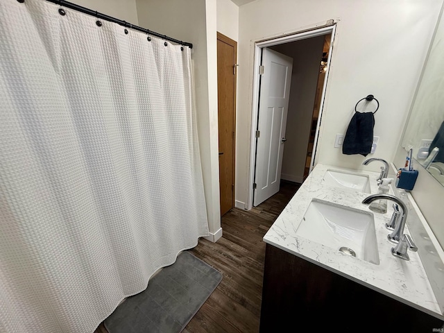 bathroom with a shower with shower curtain, hardwood / wood-style floors, and vanity