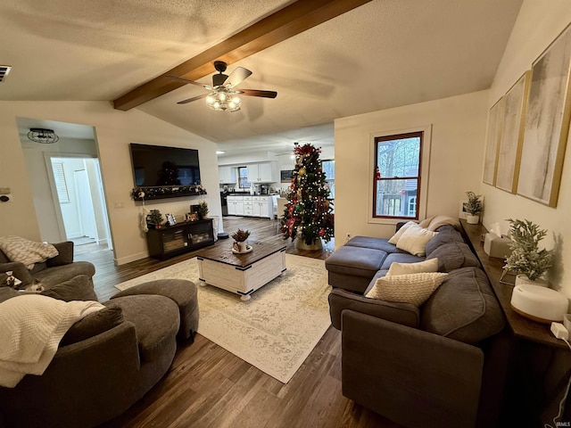 living room featuring a textured ceiling, ceiling fan, lofted ceiling with beams, and dark hardwood / wood-style floors