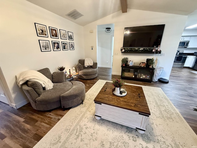 living room featuring vaulted ceiling with beams and wood-type flooring