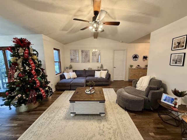 living room with a textured ceiling, ceiling fan, dark wood-type flooring, and lofted ceiling