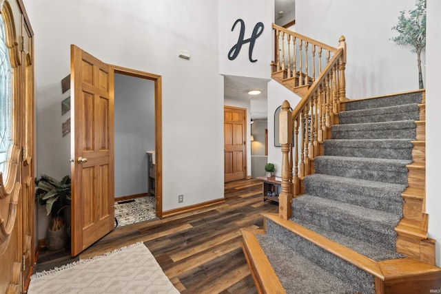 entrance foyer featuring dark hardwood / wood-style flooring and a high ceiling