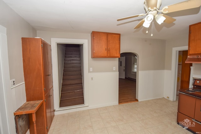 kitchen featuring range with electric cooktop, ceiling fan, and light wood-type flooring