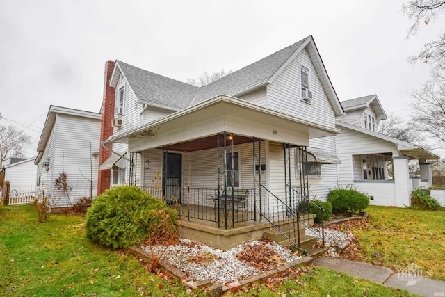 view of front of home with covered porch and a front yard