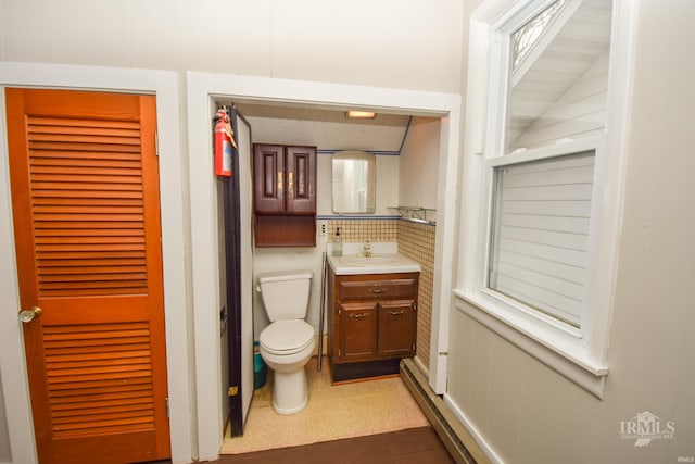 bathroom with vanity, toilet, and lofted ceiling