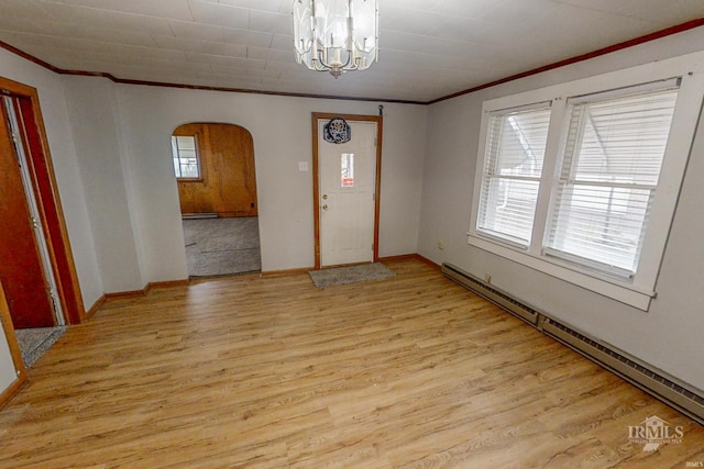 entrance foyer featuring ornamental molding, a baseboard radiator, and light hardwood / wood-style floors