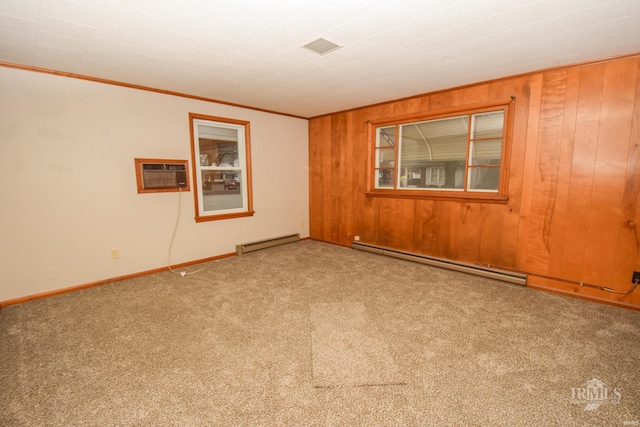 spare room with wood walls, carpet floors, a wall mounted AC, and a baseboard heating unit