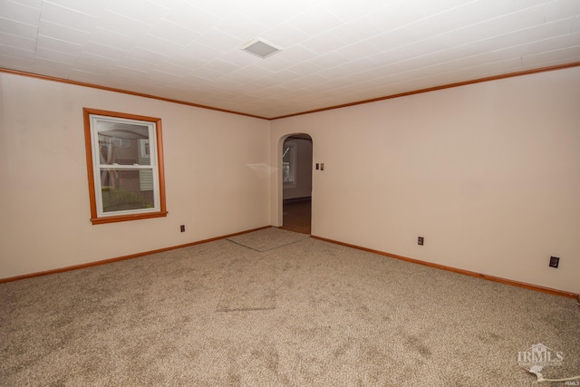 carpeted spare room featuring ornamental molding