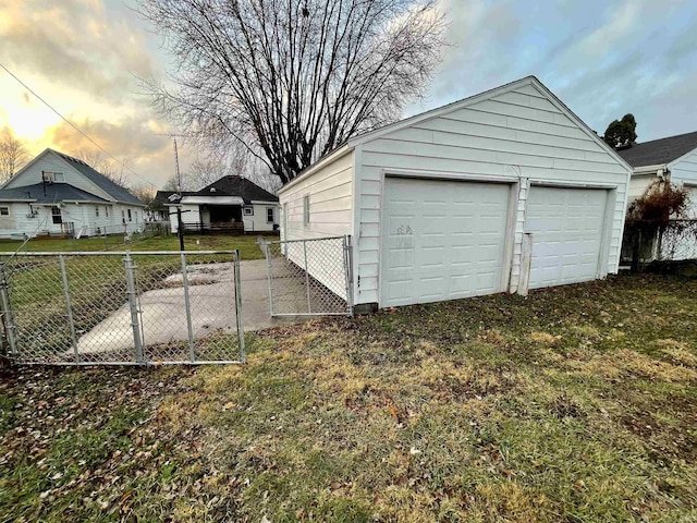 garage at dusk with a yard