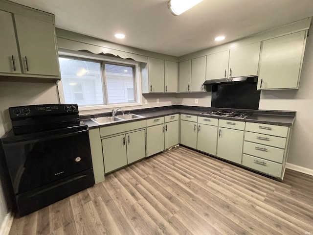 kitchen featuring light hardwood / wood-style floors, black electric range, and green cabinetry