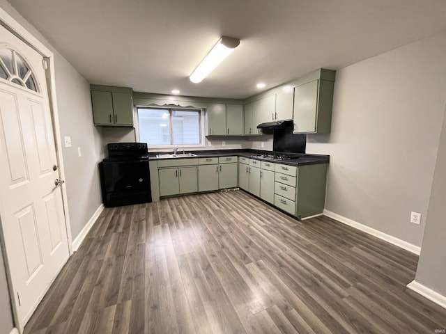 kitchen featuring green cabinets, black / electric stove, dark wood-type flooring, and stainless steel gas stovetop